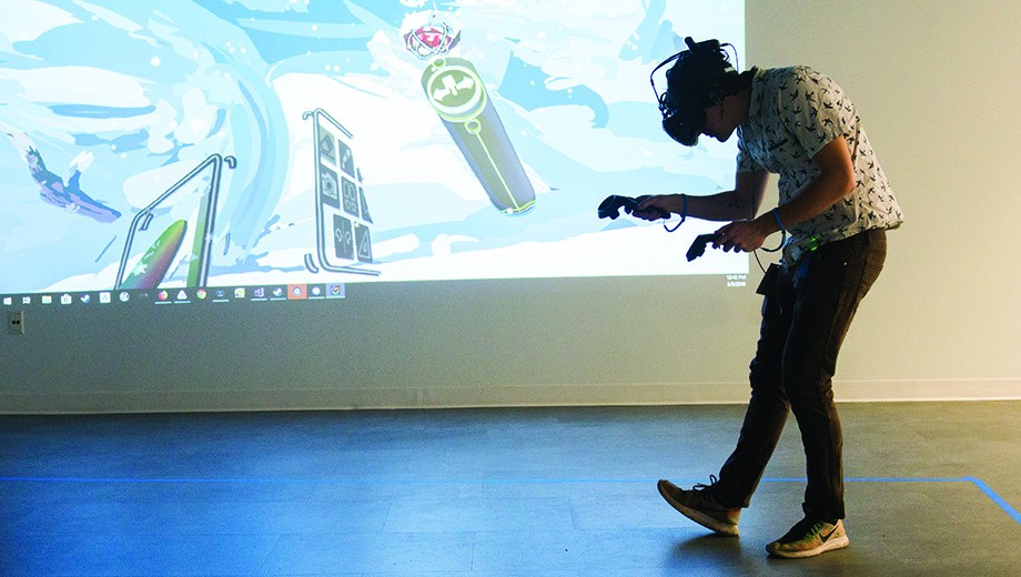 A visitor to the Media Arts, Data, and Design Center tries out the VR painting app Tilt Brush.